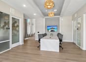 Thumbnail 106 of 124 - Conference room with frosted glass offices and ceiling fixtures at Velara Luxury Apartments, Ponte Vedra Beach
