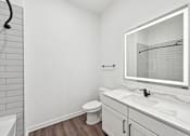 Thumbnail 60 of 60 - A white bathroom with a toilet, sink, and mirror.