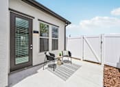 Thumbnail 31 of 43 - A white house with a grey door and a grey and white rug in front at The Hadley - North Port, FL Apartments, Florida