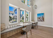 Thumbnail 107 of 124 - Dining nook with builtin bench seating and beach artwork at Velara Luxury Apartments, Ponte Vedra Beach, FL 32081