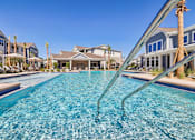 Thumbnail 19 of 124 - Resort style pool with spa and palm trees at Velara Luxury Apartments, Ponte Vedra Beach, FL