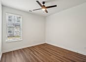 Thumbnail 90 of 105 - A room with a ceiling fan and a window with blinds. at The Pullman Luxury Apartments, Atlanta, 30349