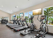 Thumbnail 26 of 62 - A gym with treadmills and exercise bikes.