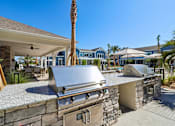 Thumbnail 93 of 124 - Outdoor kitchen with builtin grills and granite countertops at Velara Luxury Apartments, Ponte Vedra Beach, FL
