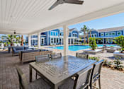 Thumbnail 109 of 124 - Covered outdoor pavilion with dining and seating area by pool at Velara Luxury Apartments, Ponte Vedra Beach, 32081