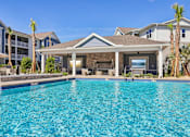 Thumbnail 20 of 124 - Swimming pool with covered pavilion and palm trees at Velara Luxury Apartments, Florida