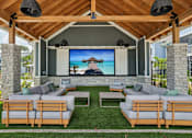 Thumbnail 9 of 62 - A wooden outdoor theater with a screen and seating.