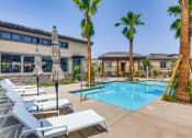 Thumbnail 35 of 68 - our apartments have a swimming pool with chairs and palm trees at Grandstone at Sunrise, Peoria, 85383