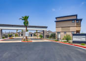 Thumbnail 32 of 68 - a building with a palm tree in front of a parking lot at Grandstone at Sunrise, Arizona