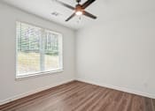 Thumbnail 94 of 105 - A room with a ceiling fan and a window with blinds. at The Pullman Luxury Apartments, Atlanta, GA