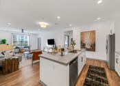 Thumbnail 19 of 45 - an open living room and kitchen with a dining area and a living room at The BLVD at Wilson Crossings, Wyoming, Michigan