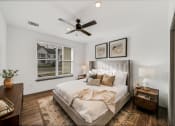 Thumbnail 11 of 45 - a bedroom with a large bed and a ceiling fan at The BLVD at Wilson Crossings, Wyoming