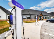 Thumbnail 17 of 45 - an electric car charging station in front of a house at The BLVD at Wilson Crossings, Michigan, 49418