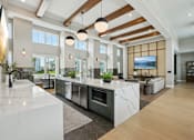Thumbnail 20 of 62 - A modern kitchen with a marble countertop and stainless steel appliances.