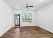 Thumbnail 27 of 124 - Empty living room with wood flooring and ceiling fan at Velara Luxury Apartments, Ponte Vedra Beach, 32081