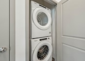 Thumbnail 60 of 68 - A white washing machine is in a cabinet. at The Sophia, Venice, FL