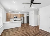 Thumbnail 32 of 124 - Open concept kitchen with wood cabinetry and island at Velara Luxury Apartments, Ponte Vedra Beach, Florida