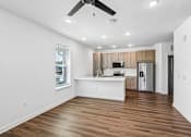Thumbnail 29 of 124 - Open concept kitchen with wood cabinets and island at Velara Luxury Apartments, Ponte Vedra Beach