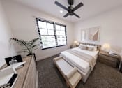 Thumbnail 4 of 18 - A bedroom with a large bed, a ceiling fan, and a window with blinds.