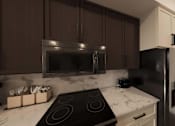 Thumbnail 32 of 45 - Kitchen with stove top oven at The Union Flats at Fishers District, Fishers, IN, 46037