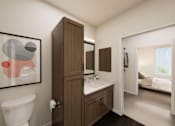 Thumbnail 19 of 48 - A bathroom with a toilet, sink, and a painting on the wall.