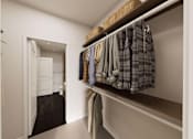 Thumbnail 13 of 48 - A hallway with a white door and a row of clothes hanging on a rail.
