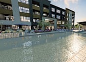 Thumbnail 18 of 35 - A large building with a pool in front.
