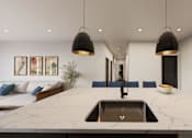 Thumbnail 24 of 35 - A modern kitchen with a marble countertop and a sink.