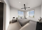 Thumbnail 28 of 35 - A bedroom with a large bed and a ceiling fan.