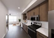 Thumbnail 40 of 45 - Kitchen with black appliances at The Union Flats at Fishers District, Fishers