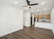 Thumbnail 100 of 105 - A room with a ceiling fan and wooden flooring. at The Pullman Luxury Apartments, Georgia, 30349