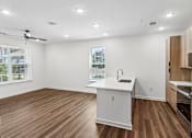 Thumbnail 26 of 124 - Open concept kitchen with island and wood style flooring at Velara Luxury Apartments, Florida