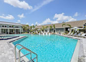 Thumbnail 10 of 62 - A large swimming pool with a metal railing on the left side.