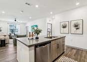 Thumbnail 37 of 62 - A modern kitchen with a stainless steel dishwasher and wooden cabinets.