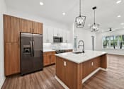 Thumbnail 52 of 60 - A modern kitchen with wooden cabinets and a marble countertop.
