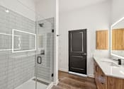Thumbnail 25 of 43 - A bathroom with a black door, a glass shower enclosure, and a white sink at The Hadley - North Port, FL Apartments, Florida, 34287