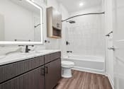 Thumbnail 23 of 24 - A white bathroom with a wooden floor and a white toilet.
