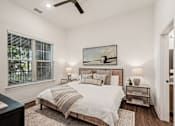 Thumbnail 26 of 57 - A bedroom with a bed, nightstands, and a painting on the wall at The Stadler Luxury Apartments, Bradenton, FL