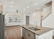 Thumbnail 58 of 68 - A modern kitchen with a stainless steel sink and refrigerator. at The Sophia, Venice, FL