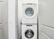 Thumbnail 51 of 62 - A white washing machine and dryer in a laundry room.