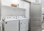 Thumbnail 20 of 31 - a small laundry room with a washer and dryer and a shelf above the washer  at Prism at Diamond Ridge, Pennsylvania, 15108
