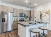 Thumbnail 6 of 31 - a kitchen with a large center island with two stools  at Prism at Diamond Ridge, Moon Township, PA