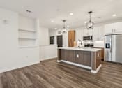 Thumbnail 40 of 62 - A kitchen with a wooden island and stainless steel appliances.