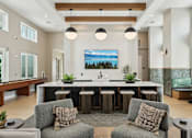 Thumbnail 21 of 62 - A modern kitchen with a large island and bar stools.