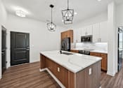 Thumbnail 58 of 60 - A kitchen with a white countertop and wooden cabinets.
