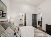 Thumbnail 25 of 57 - A bedroom with a bed, dresser, and mirror at The Stadler Luxury Apartments, Bradenton, FL 34210