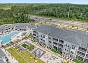 Thumbnail 4 of 64 - A large building with a pool and a chess board in front.