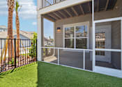 Thumbnail 15 of 124 - Screened patio with artificial turf and sliding door at Velara Luxury Apartments, Ponte Vedra Beach, 32081