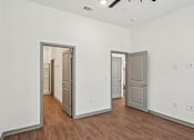 Thumbnail 65 of 68 - A room with two doors and wooden floors. at The Sophia, Venice, FL