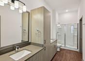 Thumbnail 66 of 68 - A modern bathroom with a sink, mirror, and wooden cabinets. at The Sophia, Venice, FL